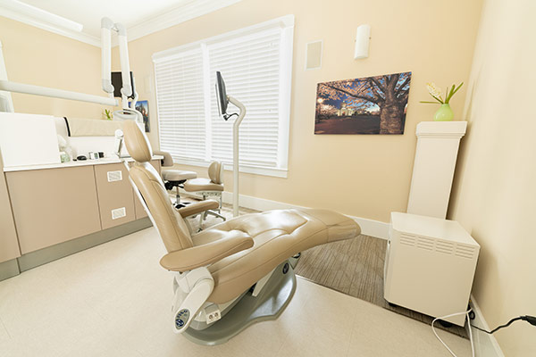Operatory with dental chair, monitor and light at Meadowlark Dental's office.
