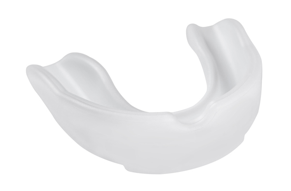 Opaque white plastic mouthguard on a white background at Meadowlark Dental in Salem, OR.